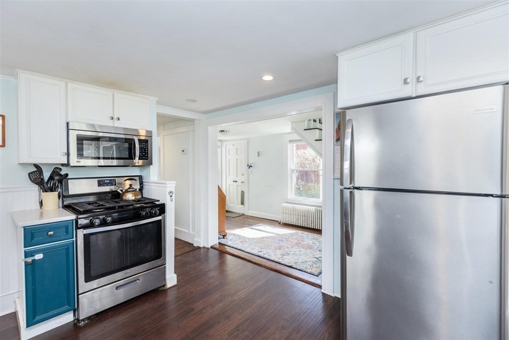 12 Linebrook Road Ipswich, MA 01938 - Photo 10 of 30 a kitchen with a refrigerator a stove and white cabinets
