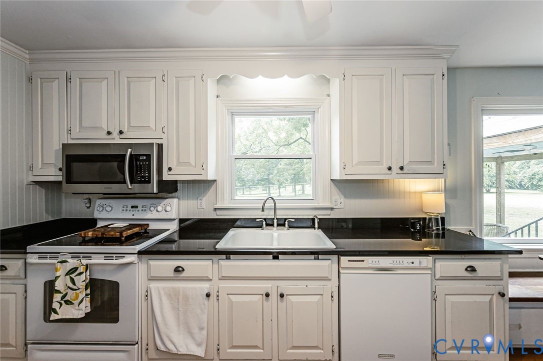 7300 Old Roxbury Road Quinton, VA 23141 - Photo 33 of 89 White cabinetry with dark hardware, a stainless st