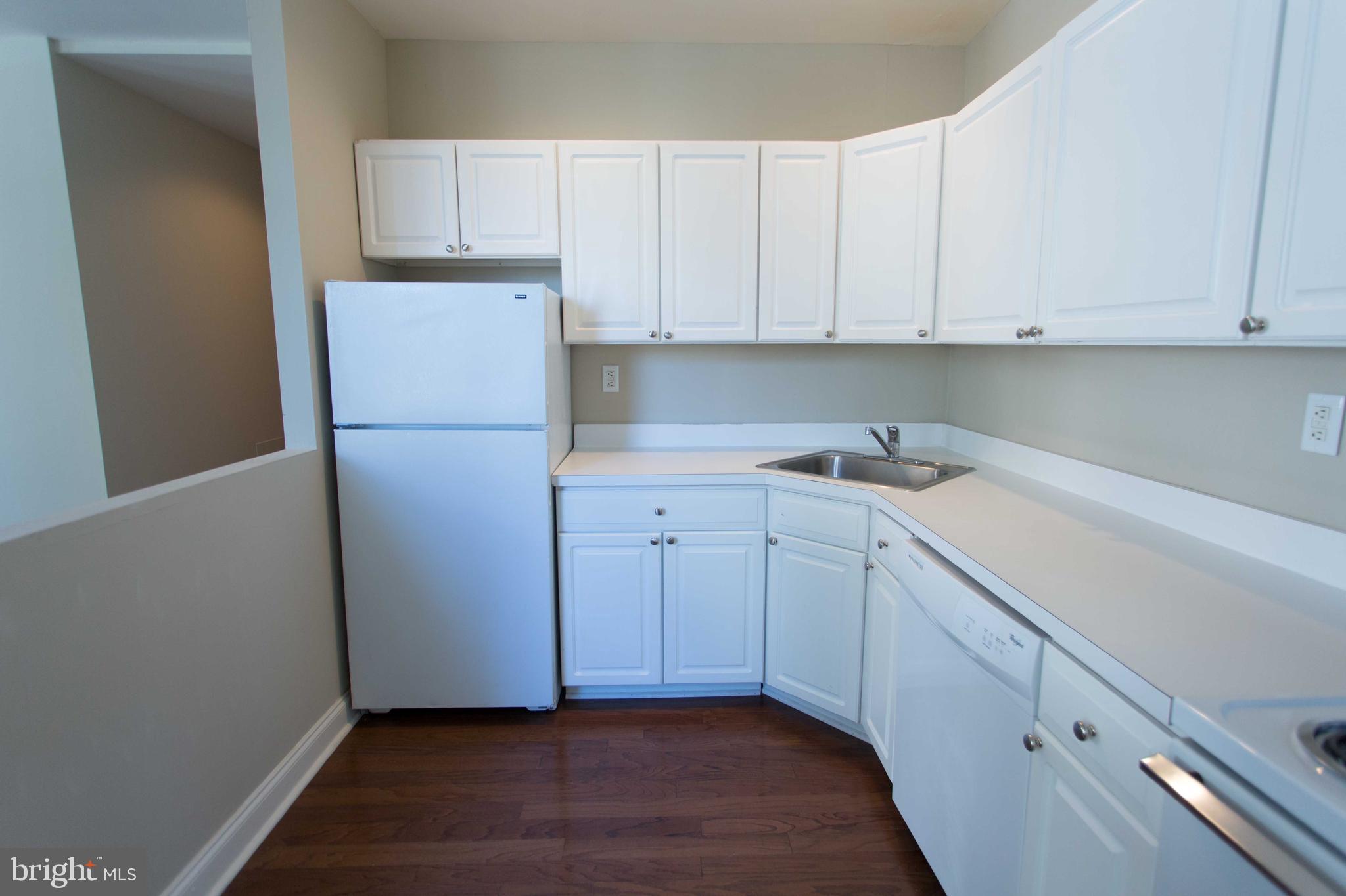 1411-5 Walnut Street, Unit 908 Philadelphia, PA 19102 - Photo 14 of 31 a view of cabinets and wooden floor