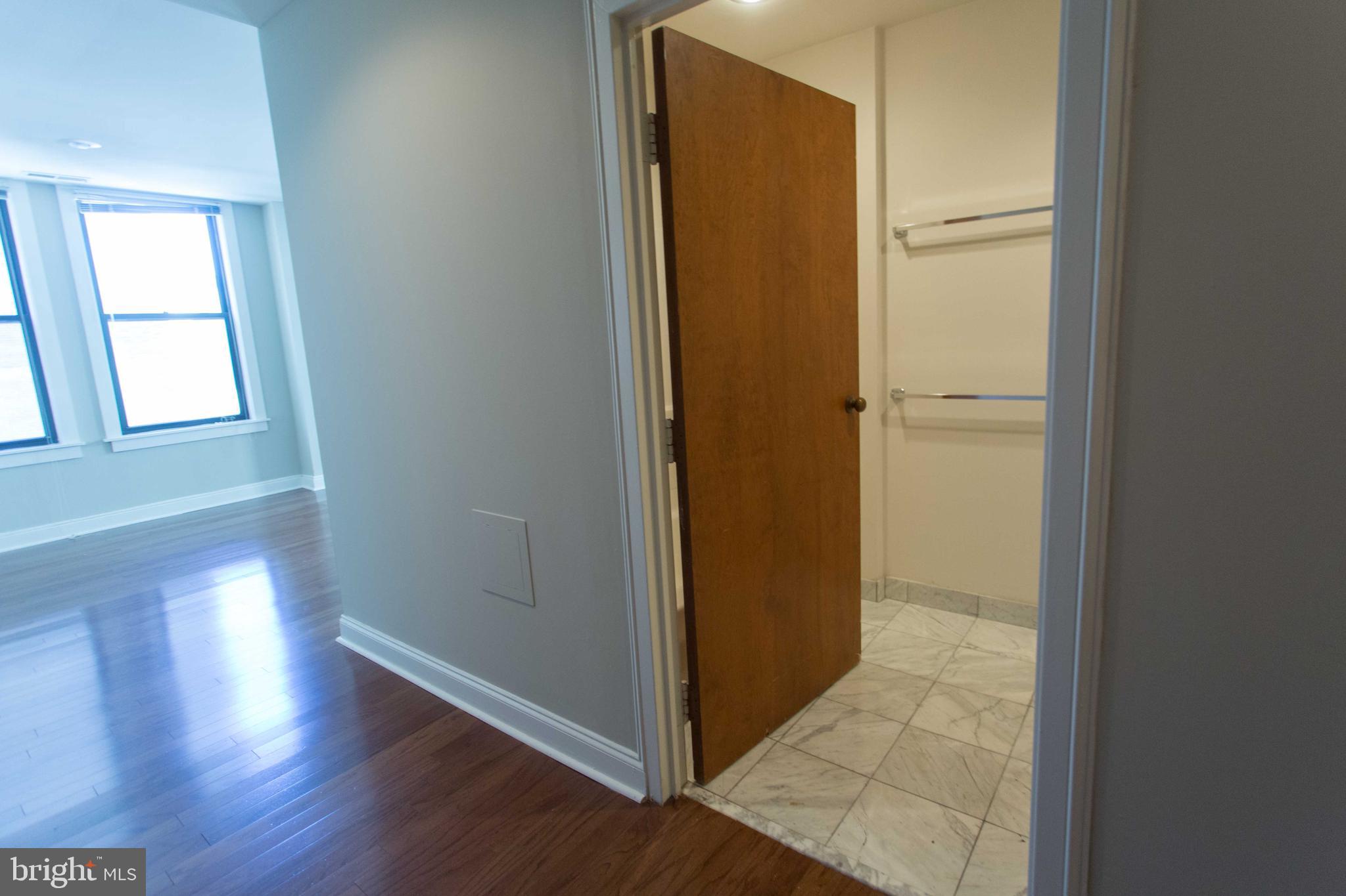 1411-5 Walnut Street, Unit 908 Philadelphia, PA 19102 - Photo 16 of 31 a view of a hallway with wooden floor