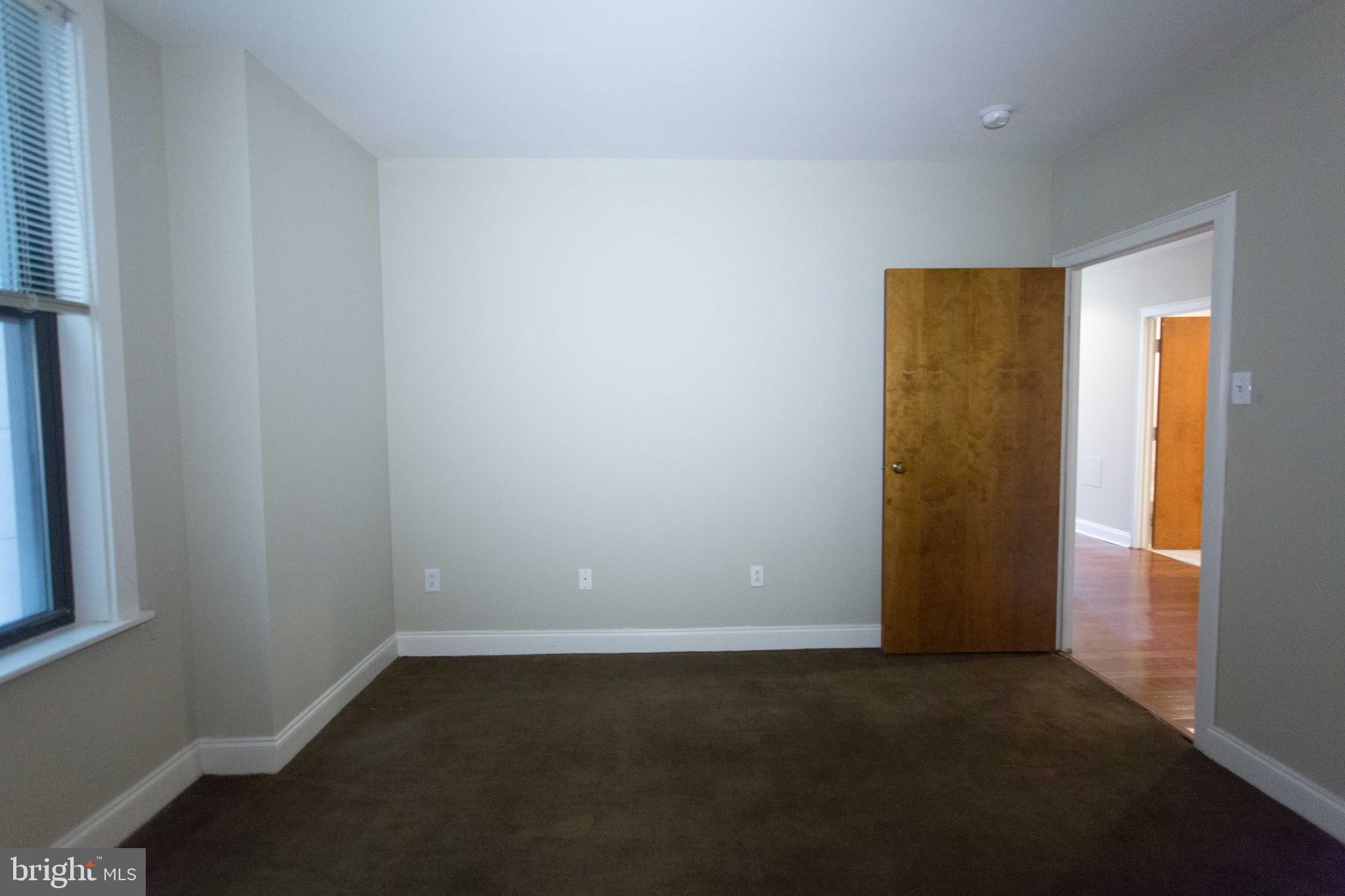 1411-5 Walnut Street, Unit 908 Philadelphia, PA 19102 - Photo 21 of 31 an empty room with a empty space and a window