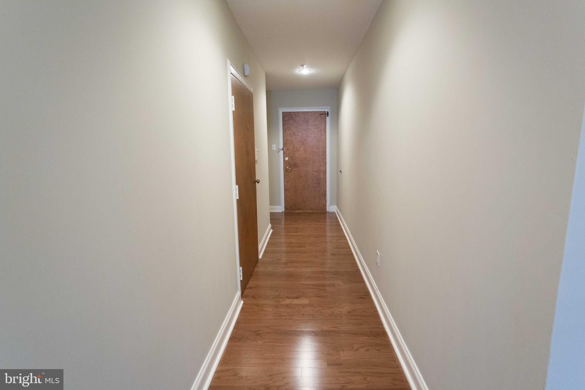 1411-5 Walnut Street, Unit 908 Philadelphia, PA 19102 - Photo 23 of 31 a view of a hallway with wooden floor
