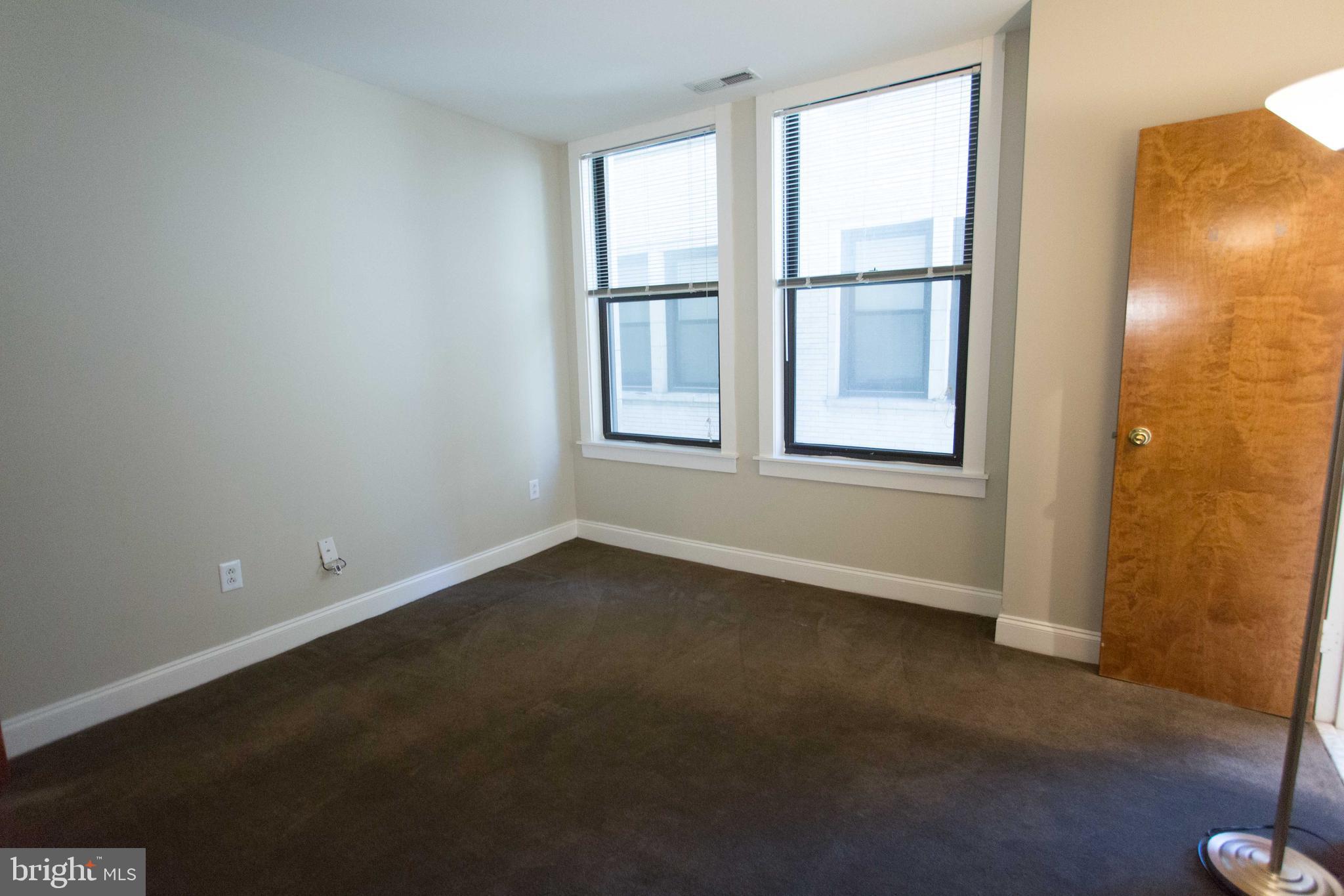 1411-5 Walnut Street, Unit 908 Philadelphia, PA 19102 - Photo 26 of 31 an empty room with a window