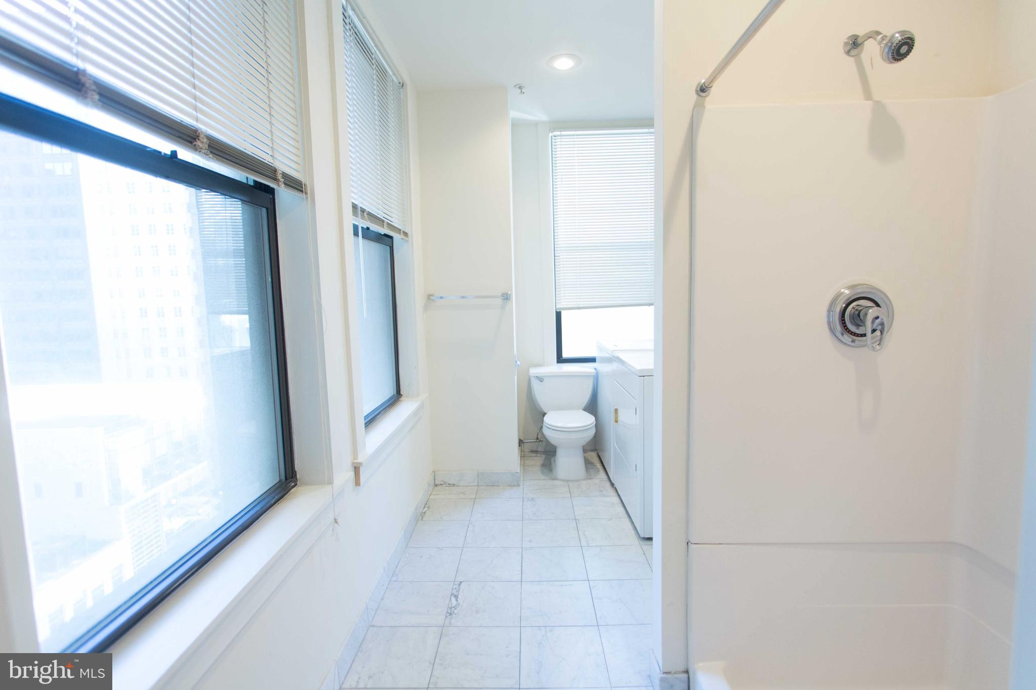 1411-5 Walnut Street, Unit 908 Philadelphia, PA 19102 - Photo 27 of 31 a bathroom with a toilet and a shower