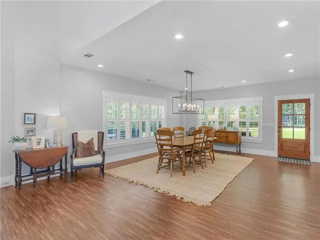 a view of a dining room with furniture and wooden floor