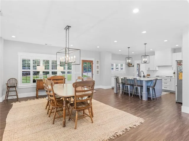 a kitchen with stainless steel appliances granite countertop a sink a refrigerator and a stove