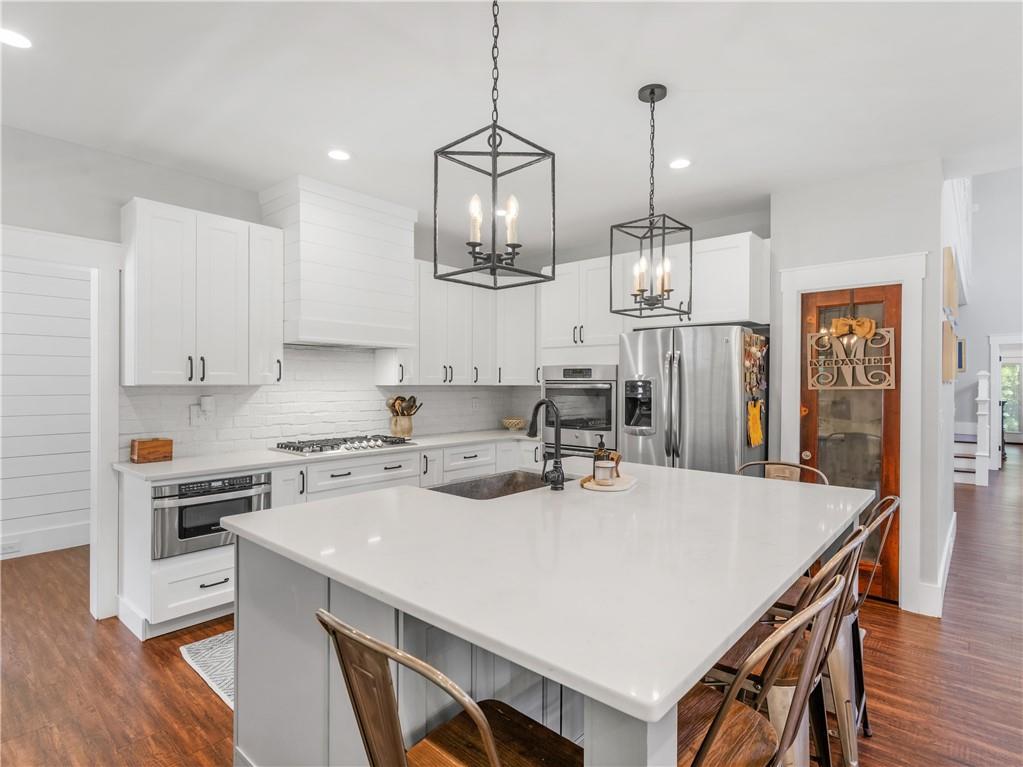 110 Wilson Road Jackson, GA 30233 - Photo 21 of 93 a kitchen with kitchen island a stove a table and chairs in it