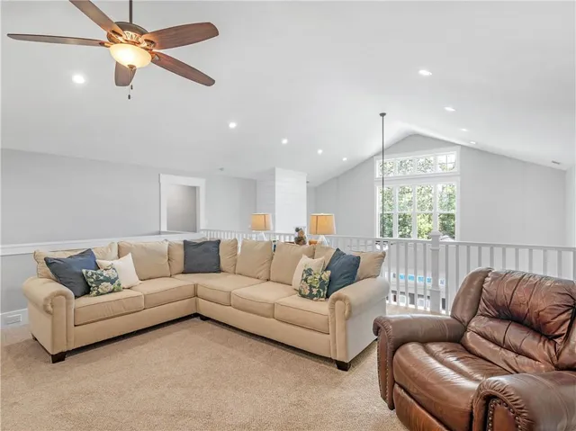 a bedroom with a bed and ceiling fan