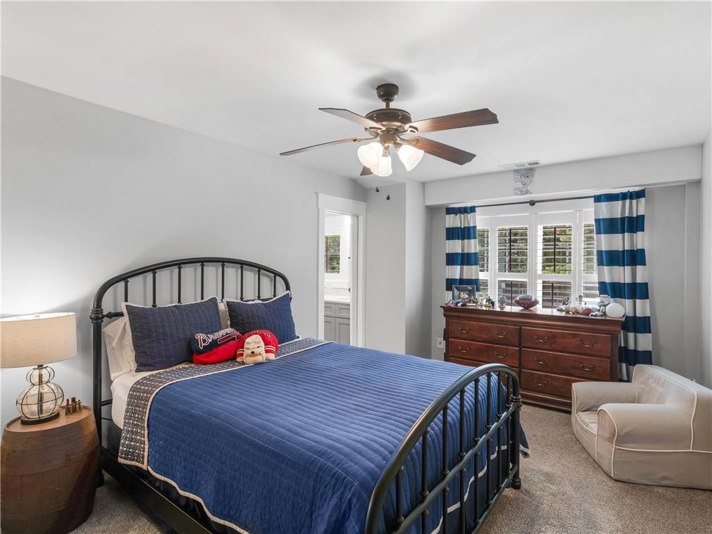 110 Wilson Road Jackson, GA 30233 - Photo 40 of 93 a bedroom with a large bed and a chandelier