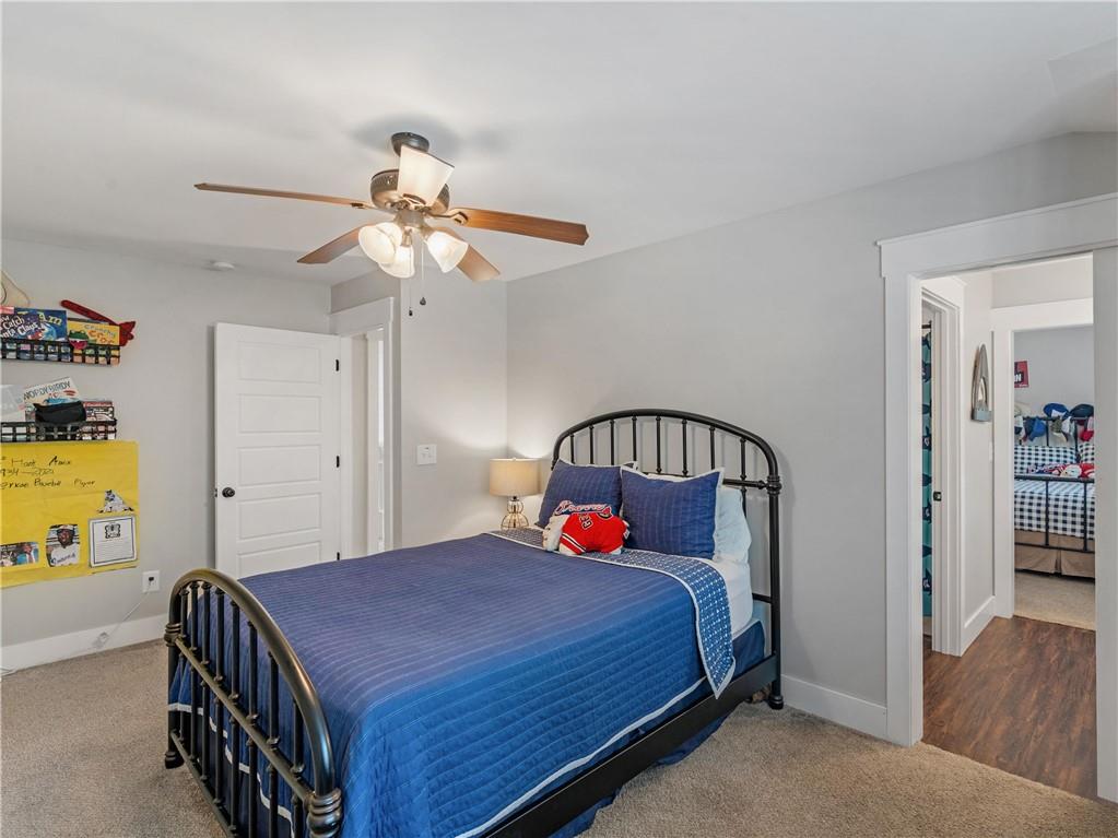 110 Wilson Road Jackson, GA 30233 - Photo 41 of 93 a bedroom with a bed and a chandelier