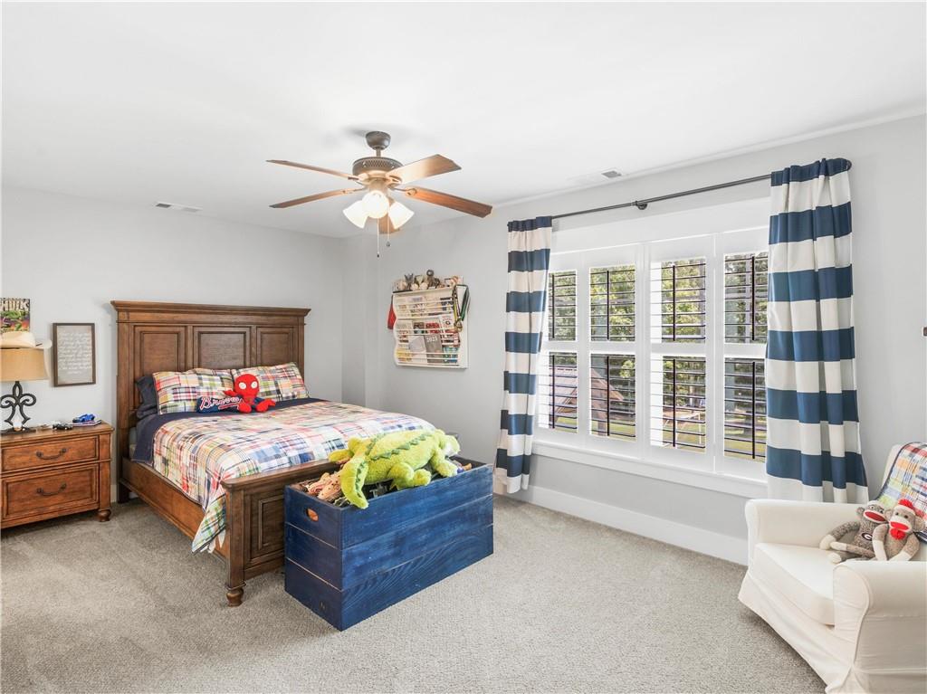 110 Wilson Road Jackson, GA 30233 - Photo 50 of 93 a bedroom with a bed and a chandelier