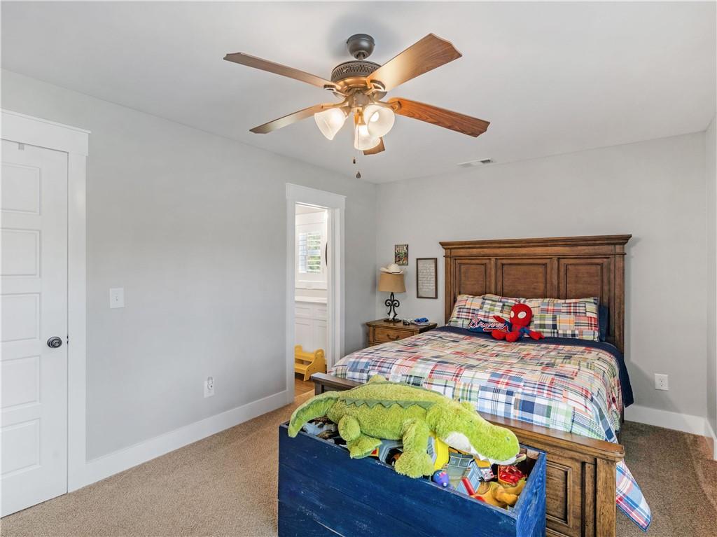110 Wilson Road Jackson, GA 30233 - Photo 51 of 93 a bedroom with a bed and ceiling fan