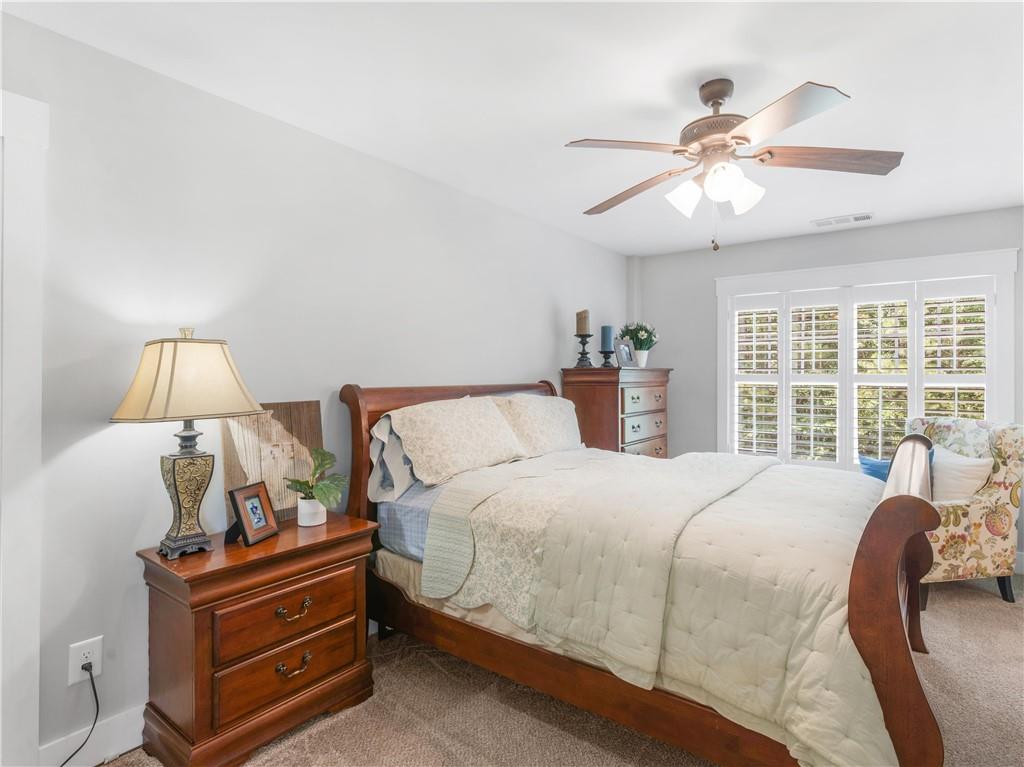 110 Wilson Road Jackson, GA 30233 - Photo 57 of 93 a bedroom with a large bed and a chandelier