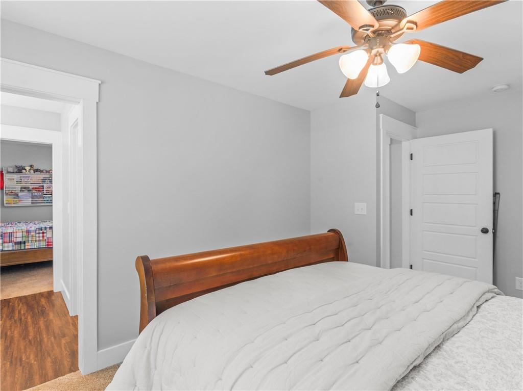 110 Wilson Road Jackson, GA 30233 - Photo 59 of 93 a bedroom with a bed and a chandelier