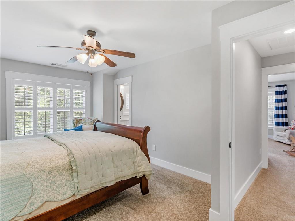 110 Wilson Road Jackson, GA 30233 - Photo 60 of 93 a bedroom with a large bed and a chandelier