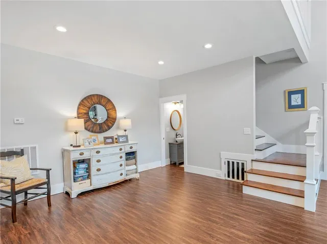 a dining room with furniture a rug and wooden floor