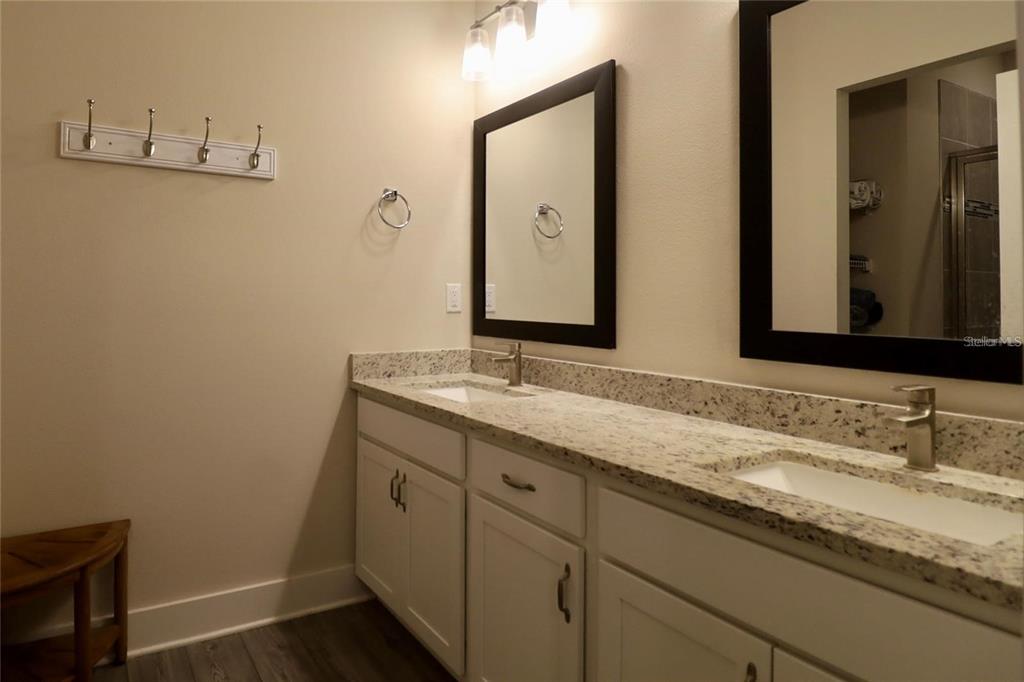 7955 Delwin Lane Reunion, FL 34747 - Photo 19 of 25 a bathroom with a granite countertop sink and a mirror