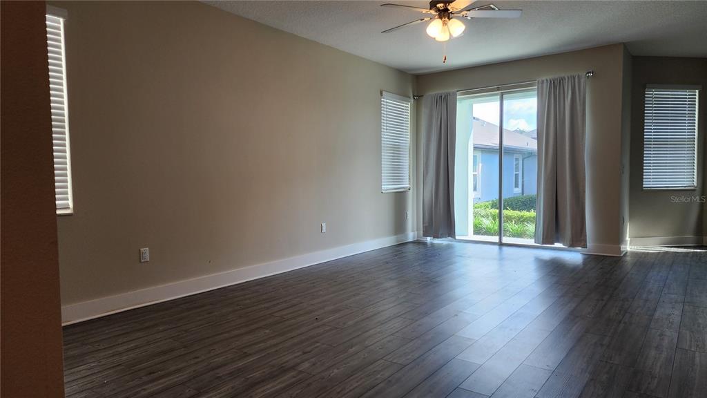 7955 Delwin Lane Reunion, FL 34747 - Photo 7 of 25 a view of an empty room with window and wooden floor