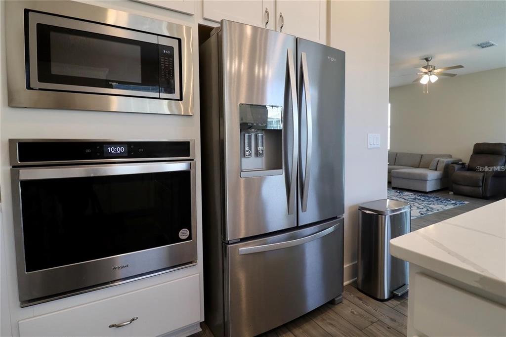 7955 Delwin Lane Reunion, FL 34747 - Photo 8 of 25 a metallic refrigerator freezer sitting in a kitchen