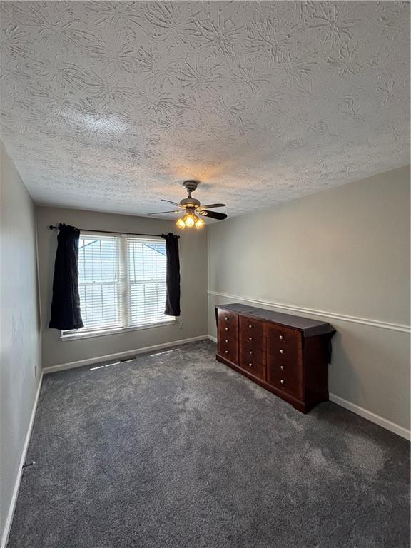 4949 Penscot Way Stone Mountain, GA 30088 - Photo 19 of 40 an empty room with windows and fan
