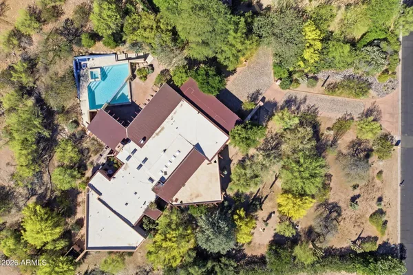an aerial view of house with yard and swimming pool