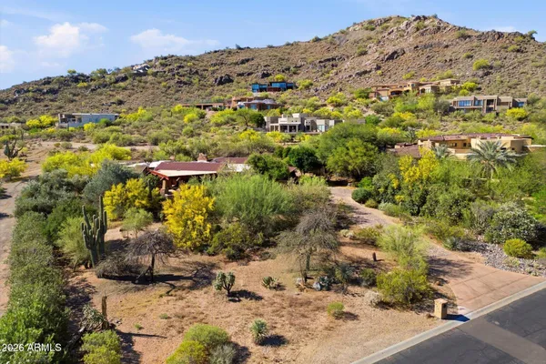 a view of a large building with mountains in the background