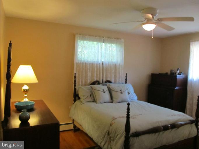 2504 Pleasantville Road Fallston, MD 21047 - Photo 20 of 30 a bedroom with a bed and a chandelier