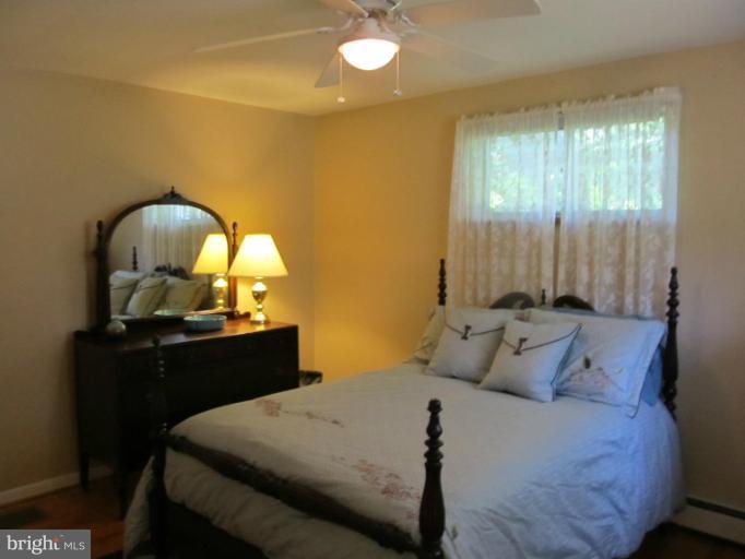 2504 Pleasantville Road Fallston, MD 21047 - Photo 27 of 30 a bedroom with a bed and a chandelier