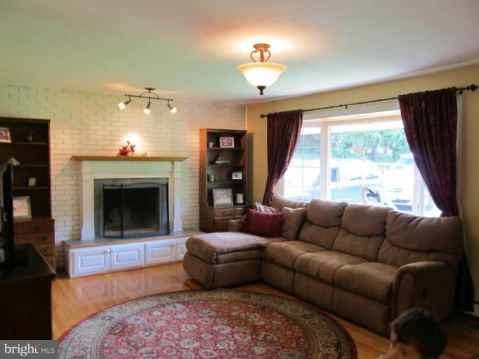 2504 Pleasantville Road Fallston, MD 21047 - Photo 4 of 30 a living room with furniture a window and a fireplace