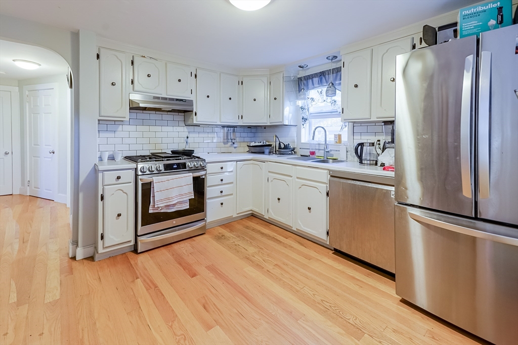 5 Oliver Street Randolph, MA 02368 - Photo 11 of 29 a kitchen with stainless steel appliances a refrigerator sink and cabinets