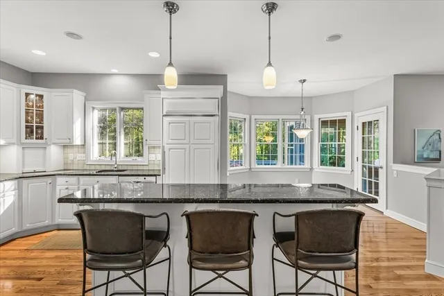 a kitchen with granite countertop wooden cabinets and a granite counter top