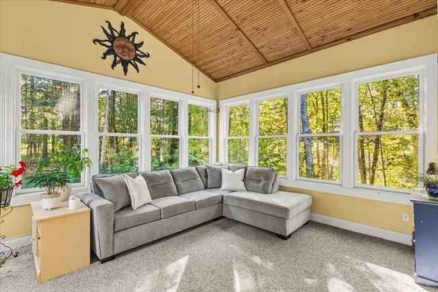 a living room with furniture and large windows
