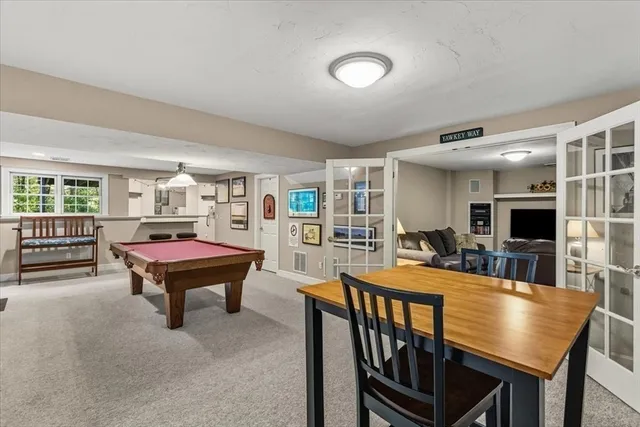a living room with furniture a flat screen tv and a table