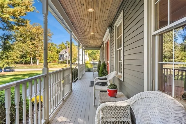 a balcony with furniture and wooden floor