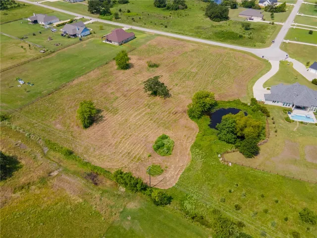 an aerial view of residential houses with yard