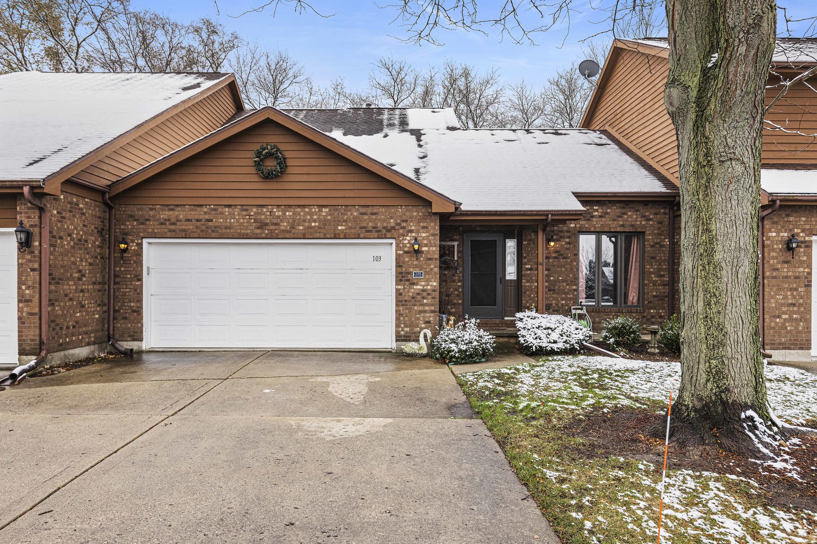 6211 Maple Street, Unit 103 Marengo, IL 60152 - Photo 1 of 20 a front view of a house with yard outdoor seating and garage