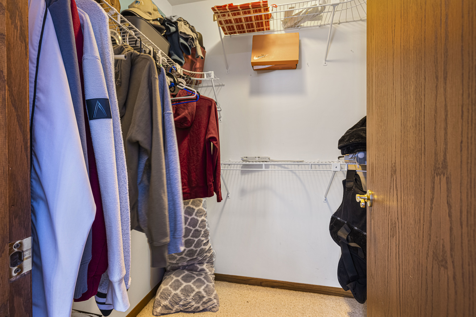 6211 Maple Street, Unit 103 Marengo, IL 60152 - Photo 13 of 20 a view of walk in closet with clothes and shoes