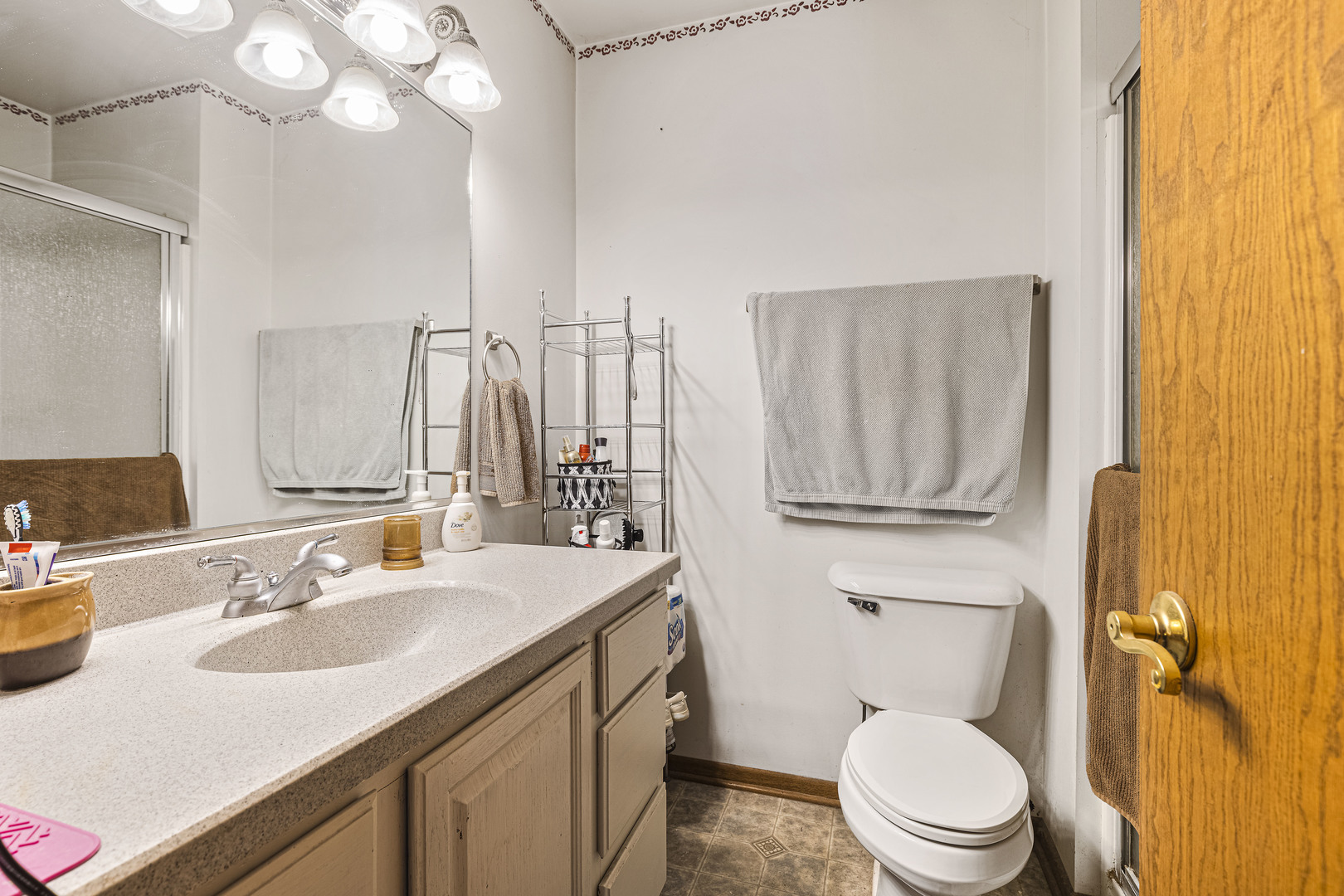 6211 Maple Street, Unit 103 Marengo, IL 60152 - Photo 16 of 20 a bathroom with a sink vanity mirror and toilet