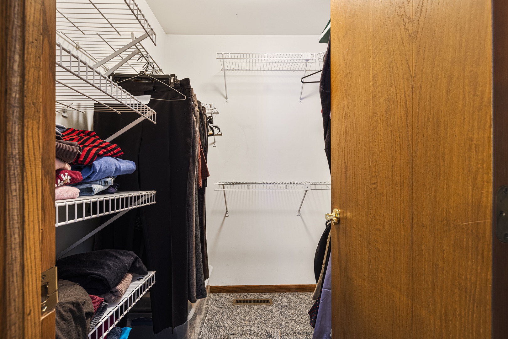 6211 Maple Street, Unit 103 Marengo, IL 60152 - Photo 17 of 20 a view of walk in closet with clothes and shoes