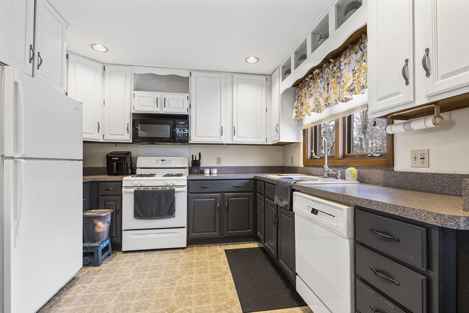 6211 Maple Street, Unit 103 Marengo, IL 60152 - Photo 4 of 20 a kitchen with a sink stove and refrigerator