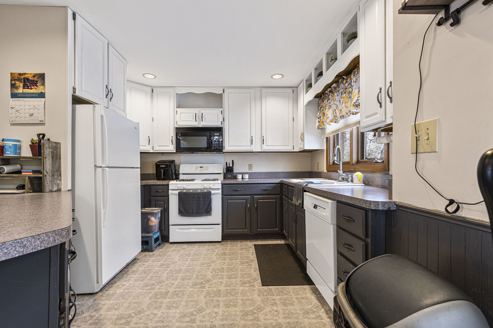 6211 Maple Street, Unit 103 Marengo, IL 60152 - Photo 8 of 20 a kitchen with stainless steel appliances a refrigerator sink and microwave