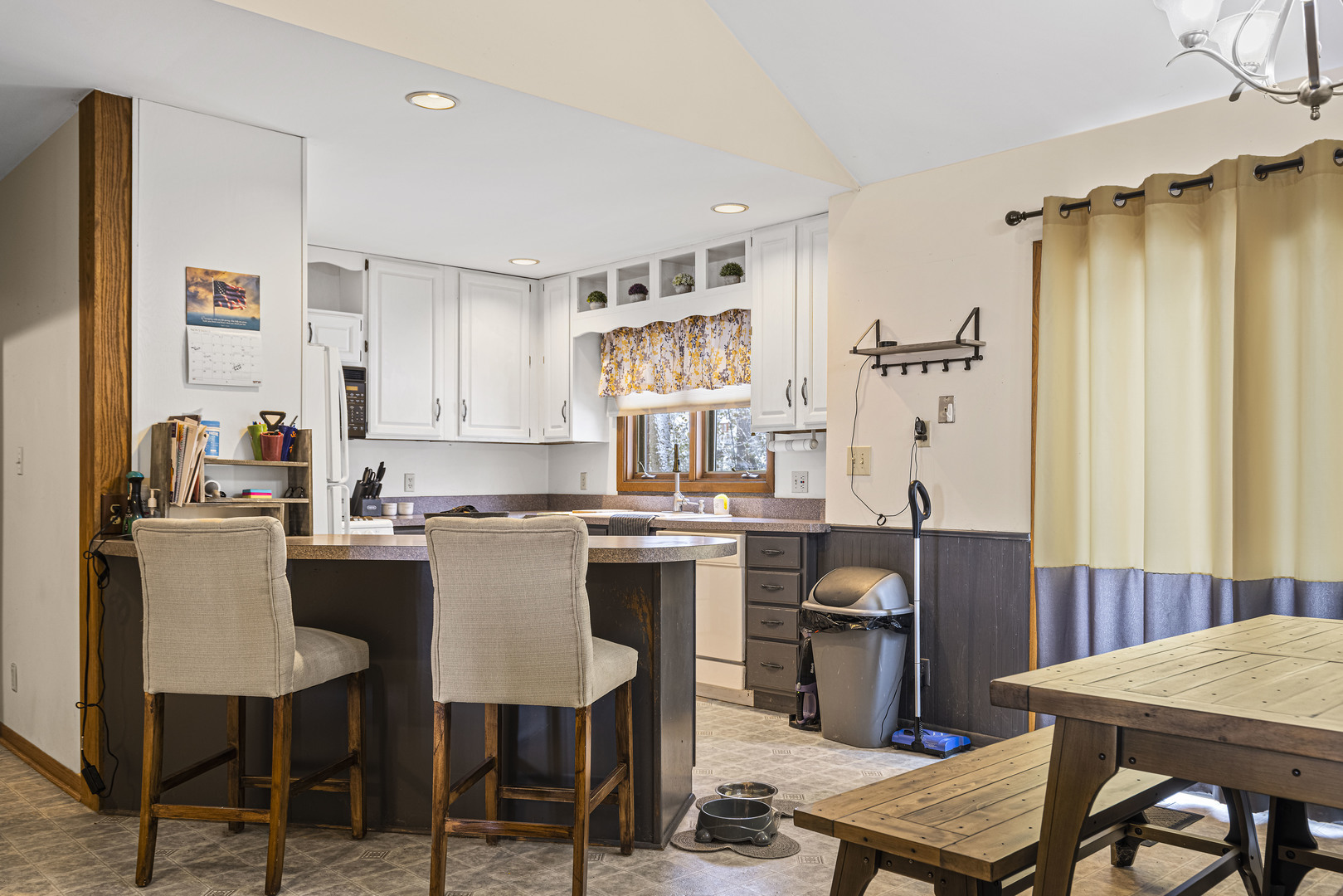 6211 Maple Street, Unit 103 Marengo, IL 60152 - Photo 9 of 20 a kitchen with a table chairs refrigerator and cabinets