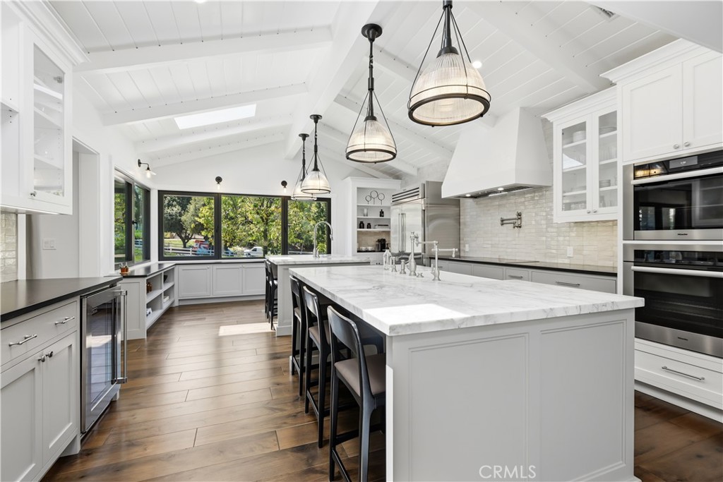 24884 Jim Bridger Road Hidden Hills, CA 91302 - Photo 6 of 31 a very nice looking kitchen with granite countertop a stove and a white cabinets