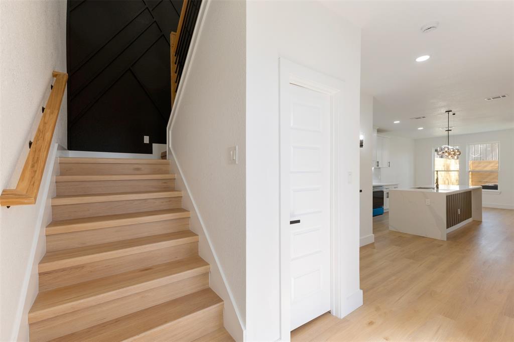 3526 Spring Avenue Dallas, TX 75210 - Photo 3 of 27 Stairs with wood finished floors and hanging lights