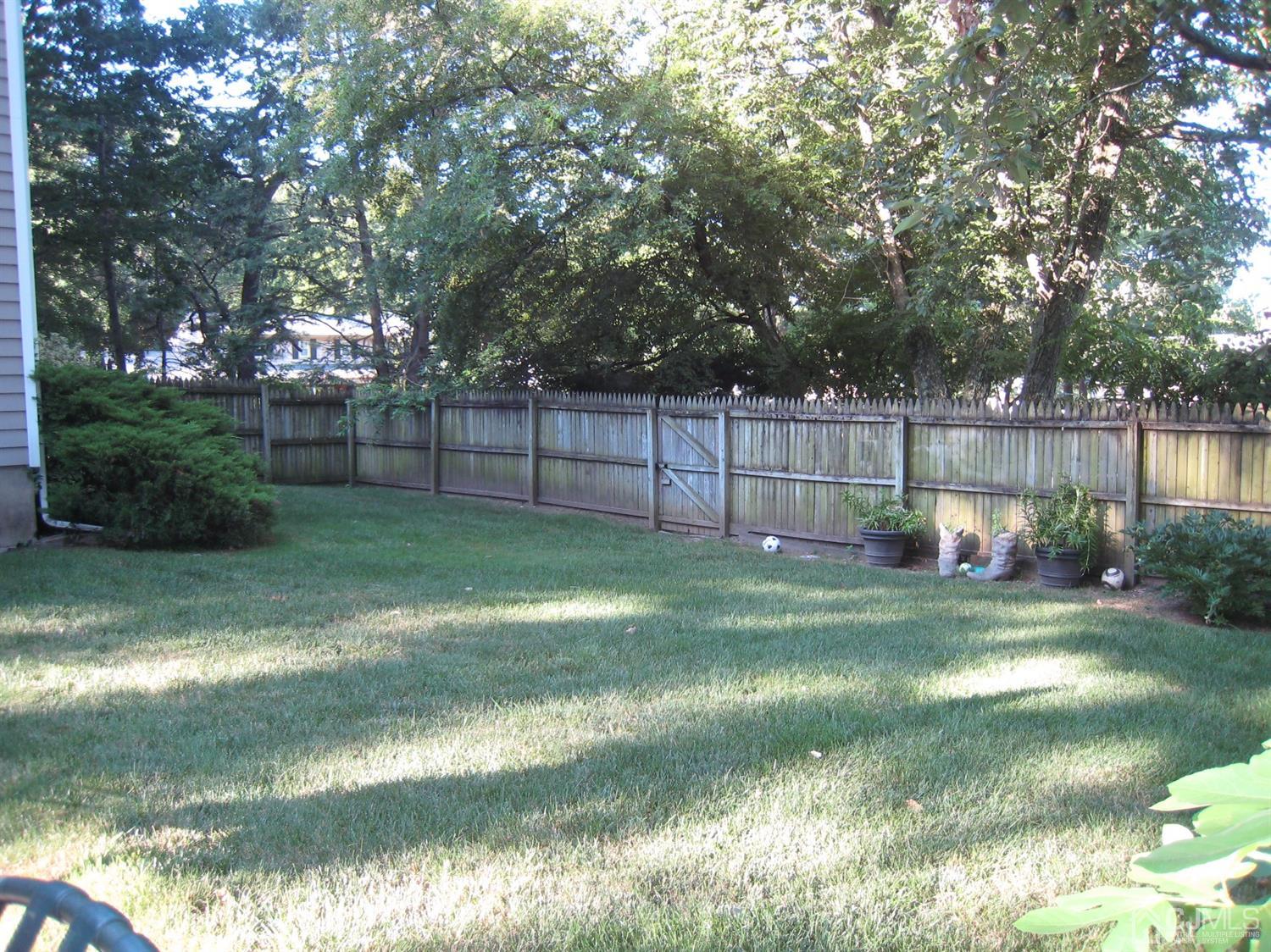 29 Revock Road East Brunswick, NJ 08816 - Photo 5 of 40 a view of a yard with a fence and trees