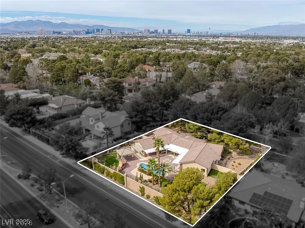 9 Quail Run Road Henderson, NV 89014 - Photo 53 of 57 An aerial perspective reveals a private oasis, blending desert landscaping with a sparkling pool and distant city views.