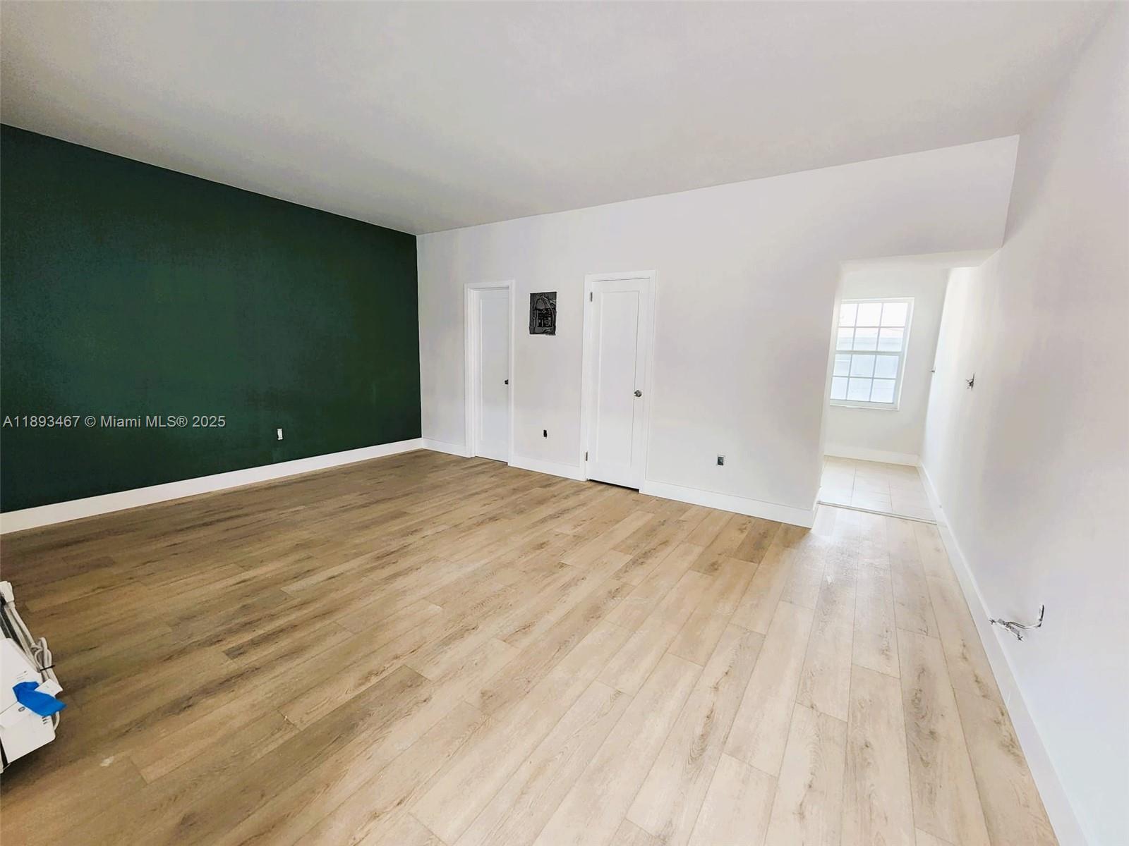 7611 Harding Avenue, Unit 8 Miami Beach, FL 33141 - Photo 6 of 19 a view of empty room with wooden floor