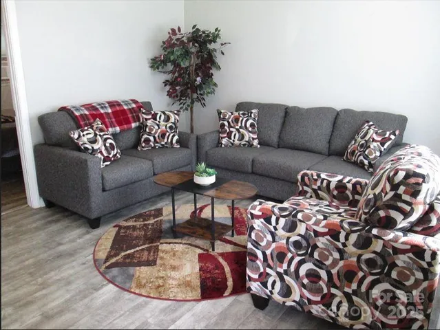 a living room with furniture or couch and a potted plant