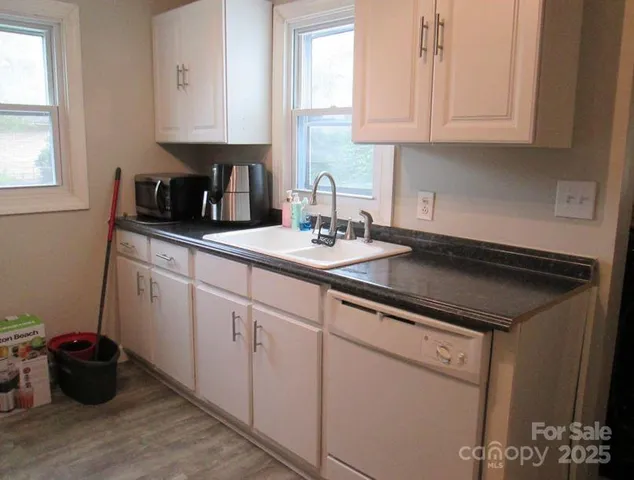 a kitchen with a sink cabinets and window