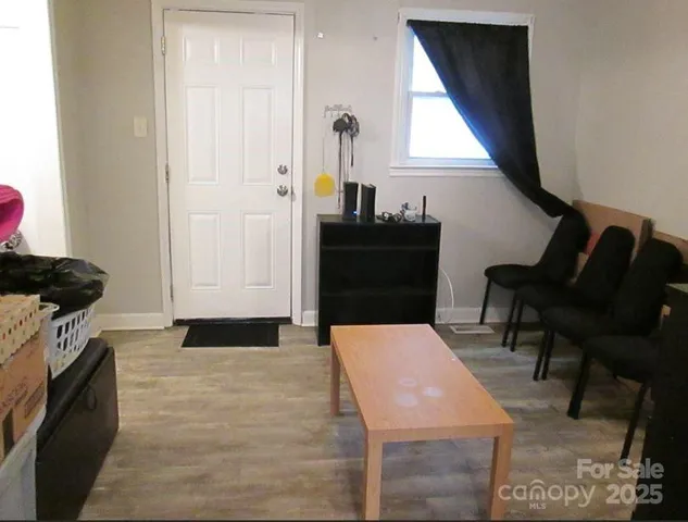 a living room with furniture a window and a fireplace